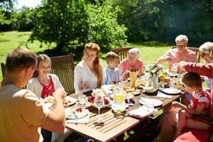 Menschen, Familie draußen an einem Tisch